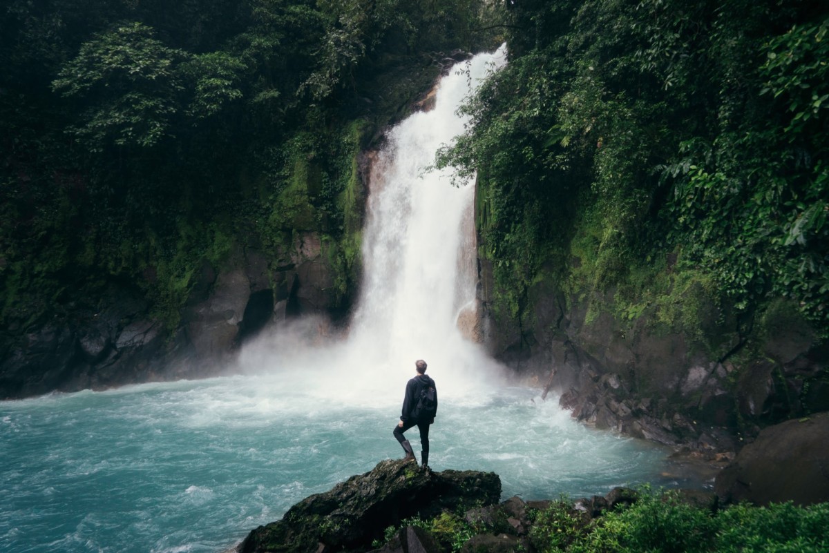 a man looking at waterfalls